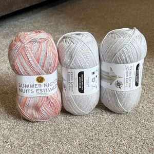 Loops & Threads and Lionbrand. 3 skeins. 2 light grey and 1 multicolor sparkle!